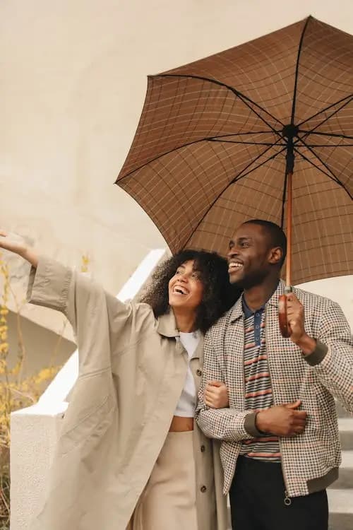 Happy travelers with luggage at airport, protected by comprehensive travel insurance